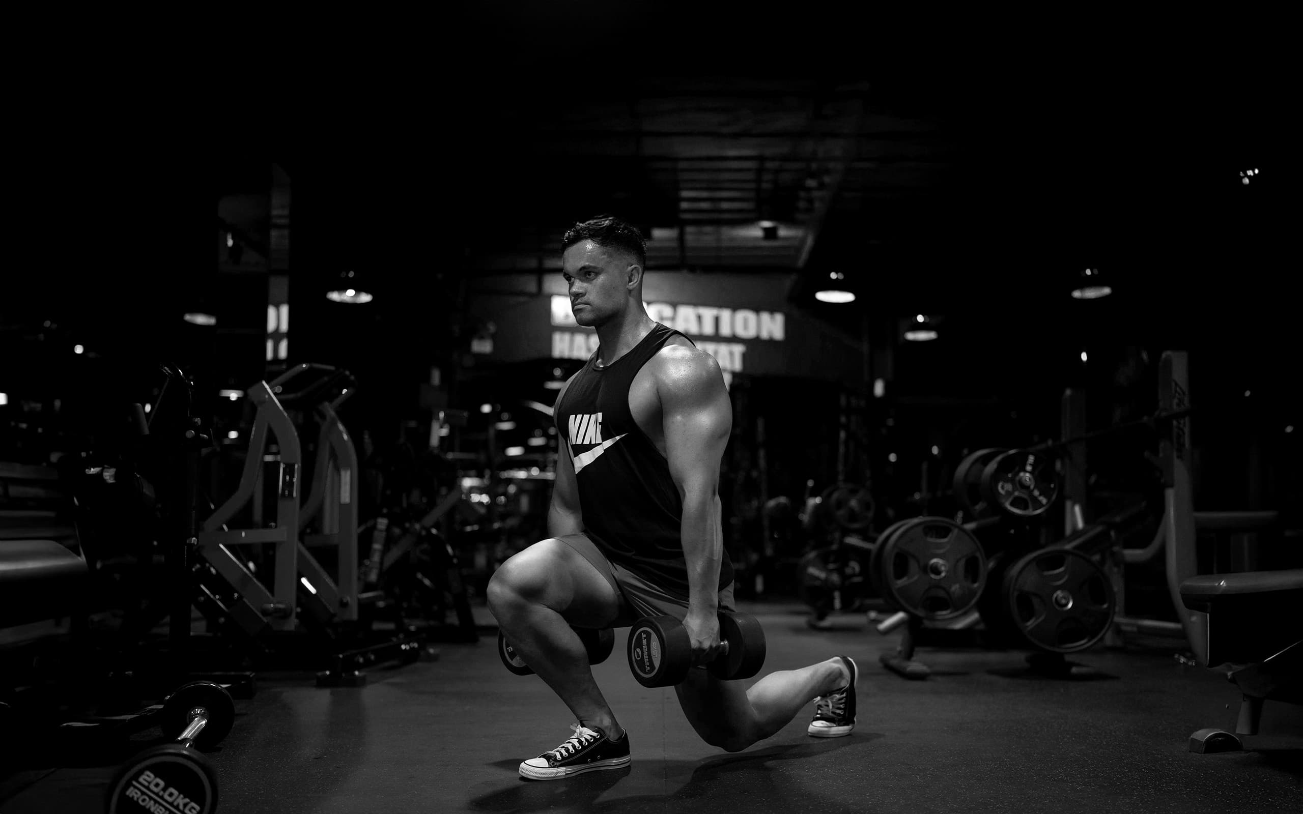 Athletes training together in a gym with weights and equipment